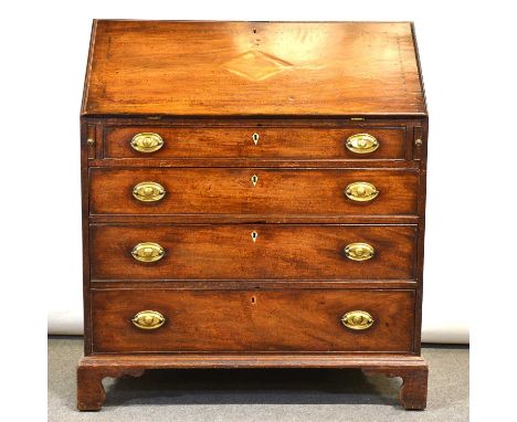 George III mahogany bureau, fall front enclosing a well fitted interior with cupboard, drawers and pigeon holes, four long gr