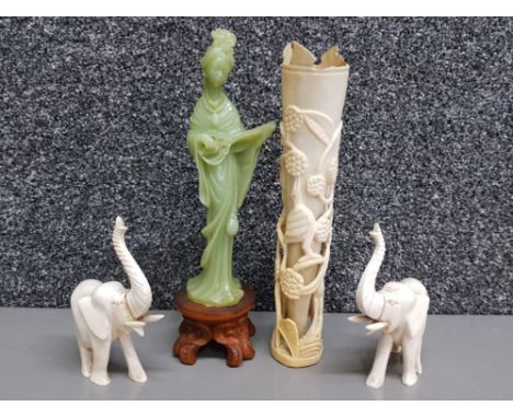 A carved horn vase and a pair of carved bone elephants, together with a jade effect Chinese musician.