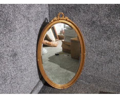 A Georgian style oval bevelled wall mirror 79.5 x 46cm