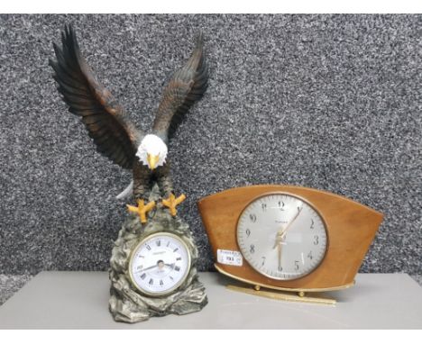 A mantle clock quartz with bald eagle to the top together with MCM retro Kienzle auto mantle clock.