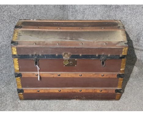 A vintage leather and brass bound domed trunk 75.5 wide.