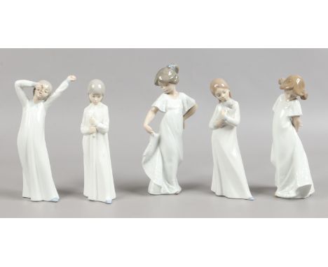 Five Nao figures modelled as children in night clothes.