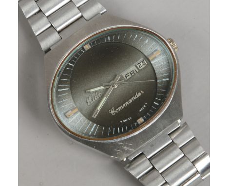 A Hido Commando bracelet wristwatch with oval dial day and date and second sweep finger on two tone grey face.