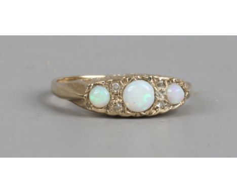 A 9ct gold ring set with three opal and diamonds, size K1/2.