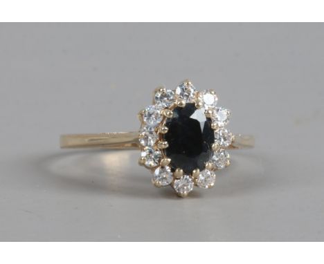 A 9ct gold sapphire and white paste coronet cluster ring, size P.