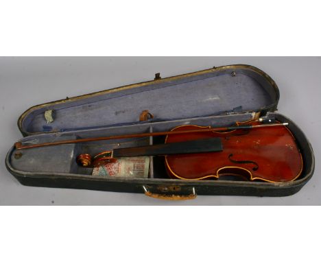 A cased Czechoslovakia violin and bow bearing label Antonius Stradivarius in need of restoration.