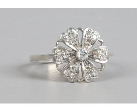 A white metal floriform ring set with diamonds, size P1/2.