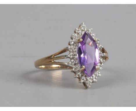 A 9ct gold ring set with marquise cut amethyst and diamonds, size O.