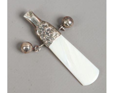 A silver babies rattle with whistle and mother of pearl teething bar.
