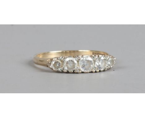 A 9ct gold ring set with five white paste stones, size P.