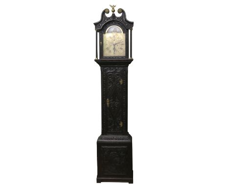 A 19th century longcase clock in heavily carved oak case  with engraved brass arch top dial incorporating a ship automaton an