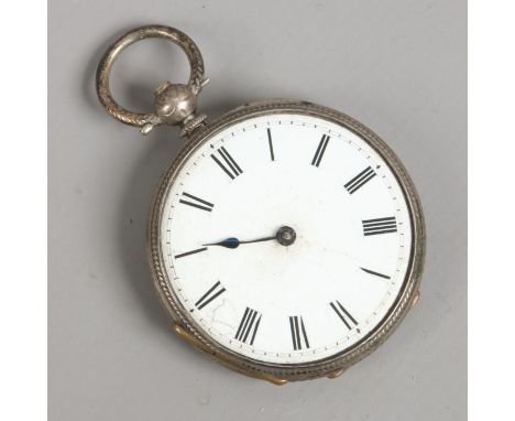 An antique silver fob watch with enamel dial.
