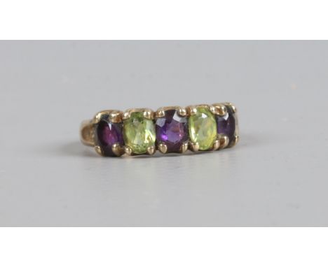 A 9ct gold five stone ring set with peridot and amethyst, size J.