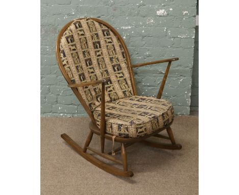 An Ercol chestnut spindle back rocking chair.