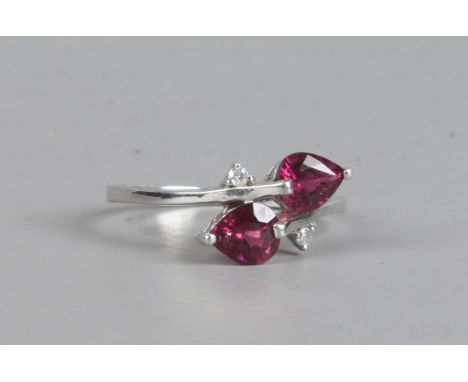 A 9ct white gold pink tourmaline and diamond ring in a cross over setting with pear cut stones, size N 1/2.