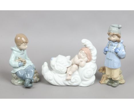 Three Nao figures modelled as children two in winter dress with animals.