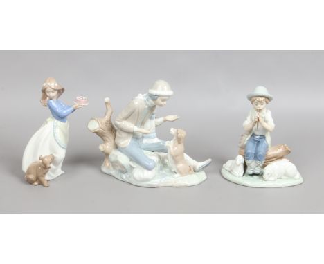 Three Nao figures, boy and a dog, girl with a cake and a shepherd boy.