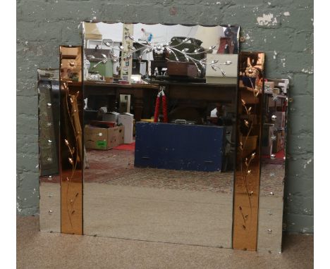 An Art Deco overmantel mirror with tinted side panels and etched with trailing flowers.