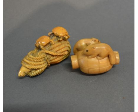 A Late 19th Early 20th Century Japanese Ivory Netsuke in the form of turtles on a rope, together with another similar netsuke