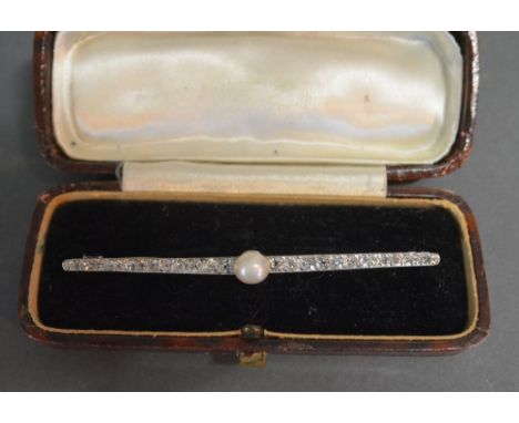 A White and Yellow Gold Long Bar Brooch set with a central pearl and many diamonds, 7.5 cms long