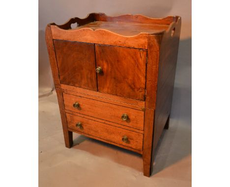 A George III Mahogany Nightstand, the shaped galleried top above two doors and a pull-out commode with two simulated drawers 