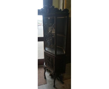 A Carved Oak Corner Cabinet, circa late 19th century, Having a glazed top, raised on cabriole legs, 165cm high, 73cm wideCond