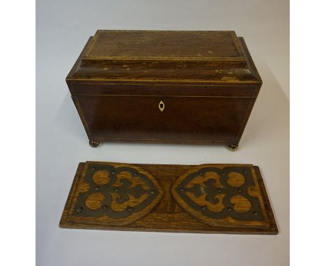 A George III Mahogany Sarcophagus Tea Caddy, Enclosing fitted compartments, lacking mixing jar, having gilt lion mask ring ha