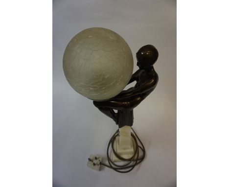 Art Deco Style Table Lamp, Modelled as a seated nude female holding the glass light shade, fitted for electricity, 46cm high