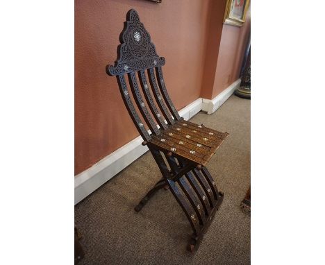 A Burmese Carved Folding Chair, circa early 20th century, Decorated with mother of pearl roundels, 104cm high