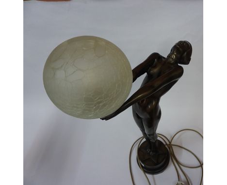 Art Deco Style Table Lamp, Modelled as a reclining nude female holding the glass light shade, fitted for electricity, 58cm hi