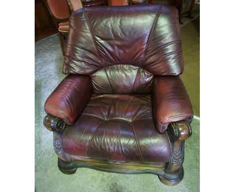 An Oak Framed Two Piece Leather Suite, Comprising of a two seater maroon leather sofa, with matching armchair, sofa 86cm high