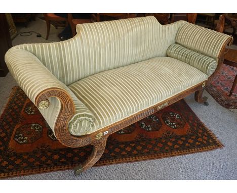 A Regency Scroll End Sofa, circa early 19th century, Decorated with parcel gilt metal roundels, upholstered in later pale gre