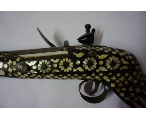 An Eastern Flintlock Long Gun, Probably of Indian Origin, circa early 19th century, Having ramrod, the steel side plate stamp