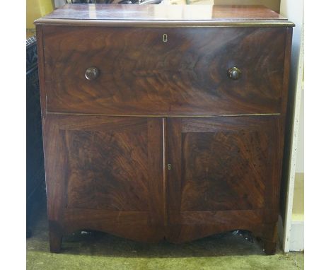An Early Victorian Mahogany Commode, circa 1840, Modelled as a cupboard chest, Having a hinged top enclosing a pine interior 