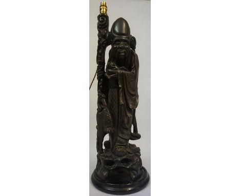 An Oriental Hardwood Figure of a Sage, circa 19th century, Of large form, converted to a table lamp, The body is inlaid with 