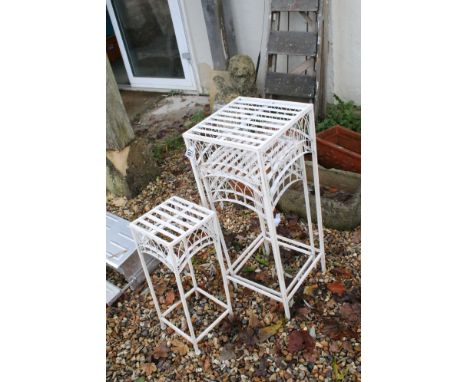 Set of three cream-painted metal graduated plant stands, the tallest 75cm high