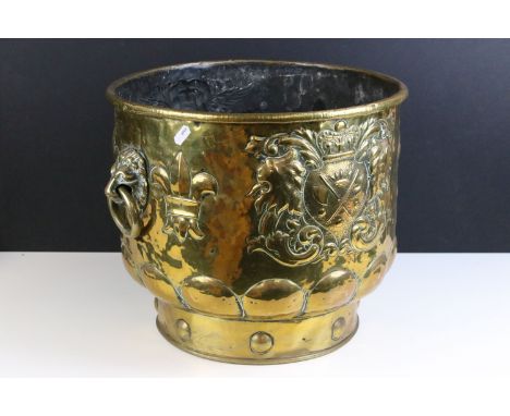 Victorian large brass coal bucket planter with lion mask handles, embossed armorials and fleur de lis decoration, diameter 37