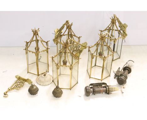 Nine brass and glass hexagonal lantern light fittings with ornate wall brackets together with  a pair of GNR railway carriage