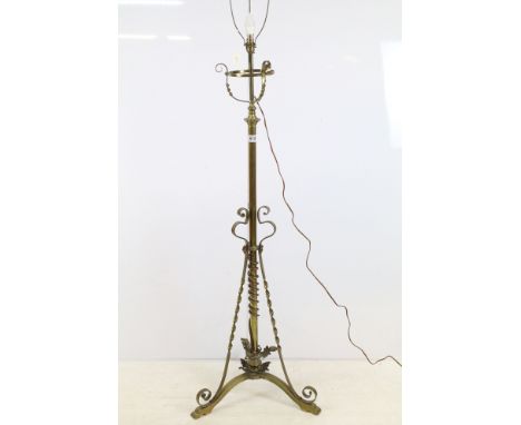 Tall 20th century brass floor lamp with ornately decorated stem base, foliage detail and three splayed scroll feet, 142cm to 