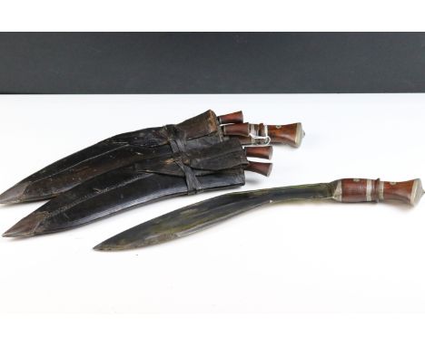 Two mid 20th century Kukri knives, Chirra blade with grooved fuller, wooden grips and leather covered wooden scabbard, both b