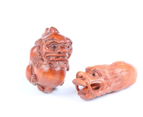 Two carved wooden netsuke figures of Chinese dragons, one holding a large ball signed