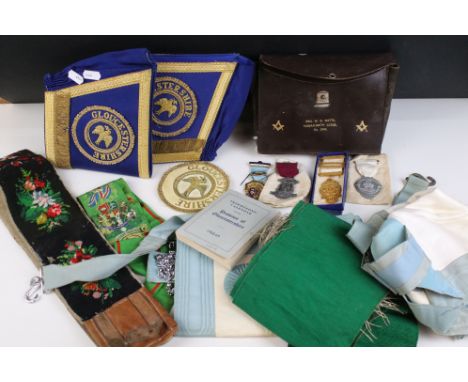 A collection of masonic collectables to include jewels, sashes, books and associated regalia.