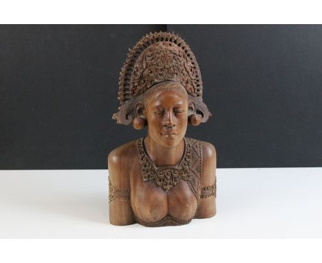 Balinese carved wooden bust of a woman with ornate ceremonial head-dress, H 41cm