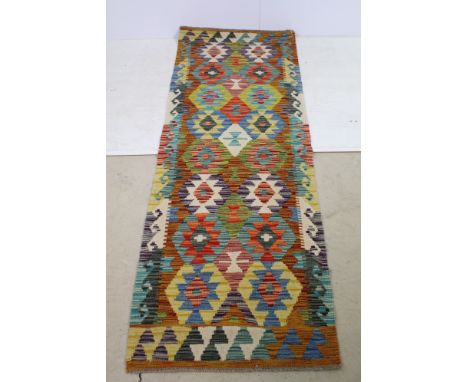 Chobi Kilim runner rug having a woven coloured geometric design. Measures 200 x 69cm.