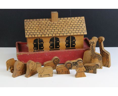 Vintage wooden part painted Noah’s Ark with lift off lid and raised on roller wheels, havingtwelve wooden animals and figures