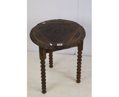 Oak hand carved circular tripod base side table on turned legs with flora pattern to top, H 56cm, diameter 47.5cm