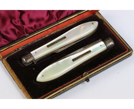 A cased hallmarked sterling silver and mother of pearl folding knife and fork set.