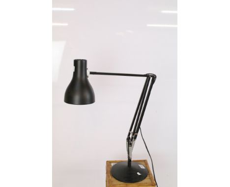 Anglepoise lamp having a round black base with mechanical arm and conical shade. Measures 84cm tall. 