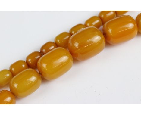 An amber style beaded necklace with beads of cylindrical form. 