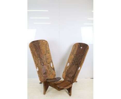 20th century pair of Malawian hardwood two piece carved tribal chairs with bird and fish design and cut out handles to backs,